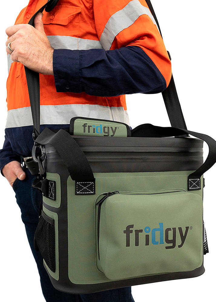 Man in high-vis holding the Fridgy 14L CribMate with shoulder strap – Durable, insulated soft cooler designed for keeping food and drinks fresh on long workdays.