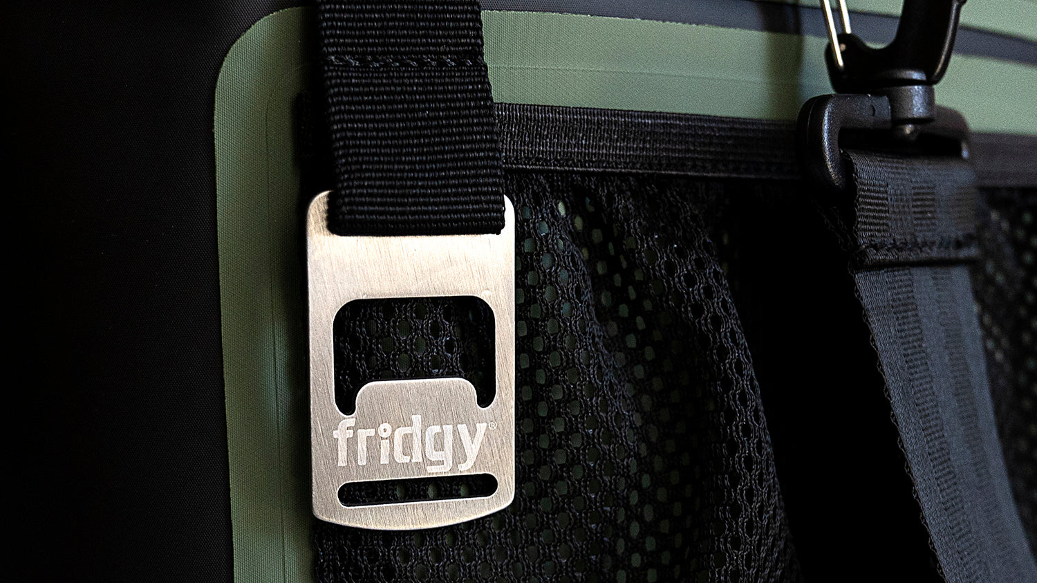 Ultra close-up of built-in bottle opener on Fridgy 14L CribMate in Commando Green – Insulated soft cooler showcasing its durable, integrated bottle opener and rugged construction.