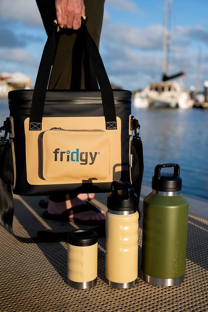 Fridgy CribMate Soft Cooler alongside a Can Cooler, 1080ml Grip Range Bottle, and 1.9L All-Dayer – Durable, insulated gear designed to keep food and drinks fresh and cold all day.
