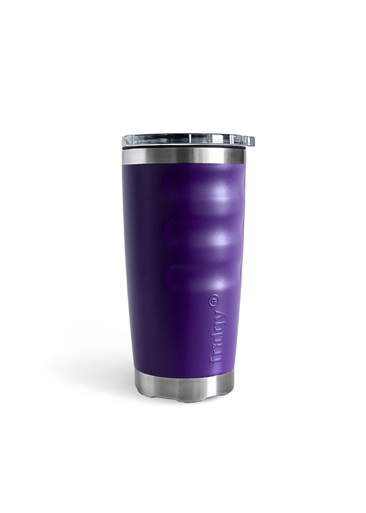 Man in a hat and khaki shirt holding a 600ml tumbler sitting with a dog, both on a dirt path.