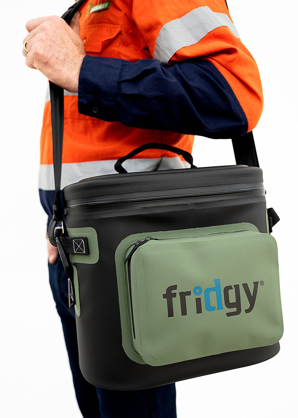 Man in high-vis carrying Fridgy 8L CribMate in Commando Green over his shoulder – Insulated soft cooler designed for durability, comfort, and keeping food and drinks fresh on the job site.