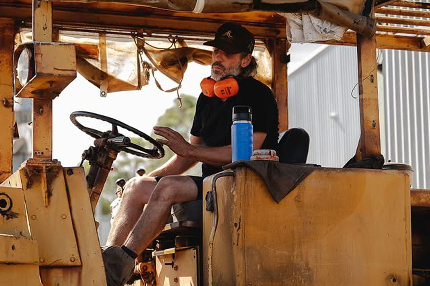 ridgy 780ml Grip Range Bottle – Triple-wall insulated stainless steel water bottle placed next to an Aussie working hard, built for all-day hydration in tough conditions.