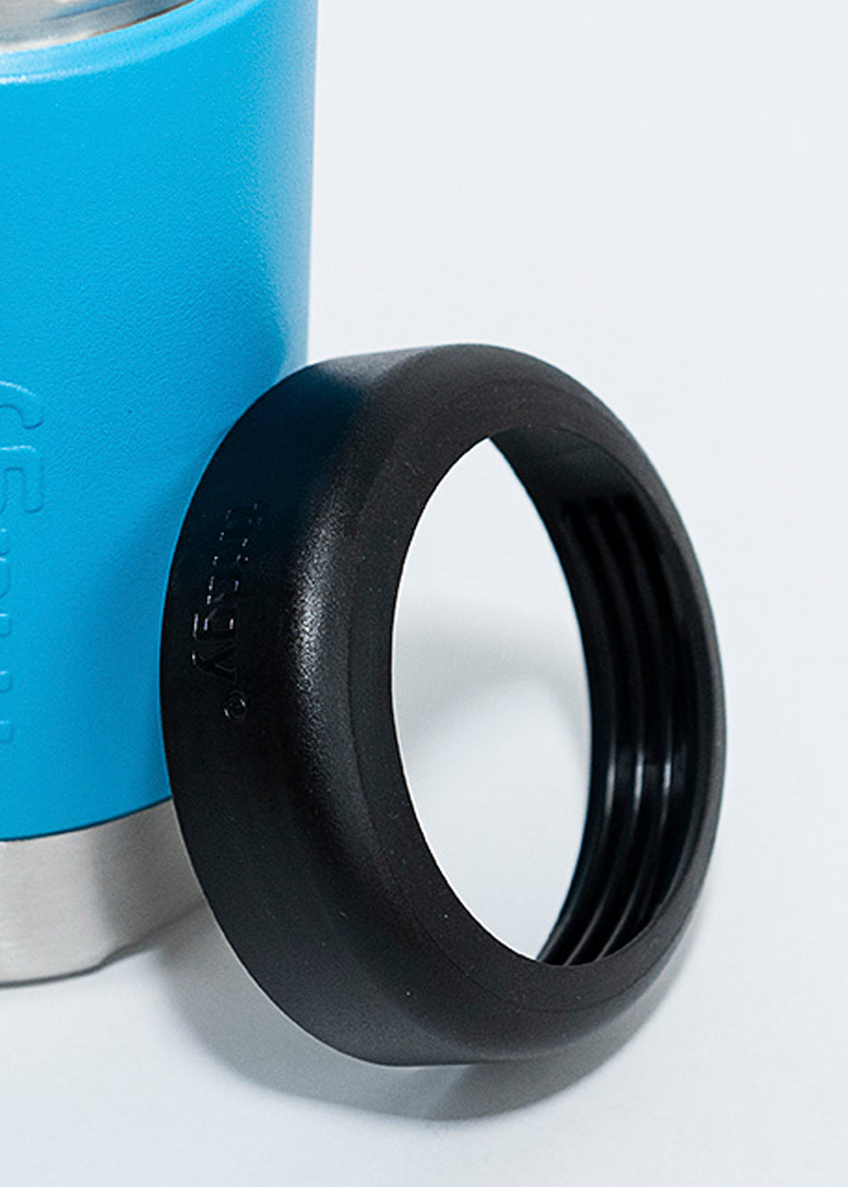 Fridgy 375ml Can Cooler in Regal Blue with its lid leaning against it – Double-wall insulated stainless steel can holder designed to keep drinks cold for hours.