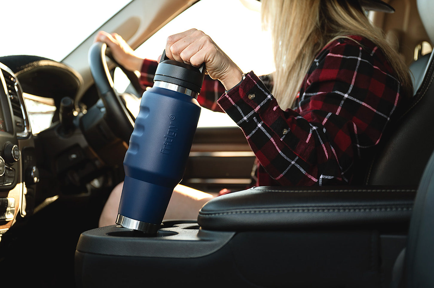 Fridgy 1L Cruise Range Bottle being removed from a car cup holder – Triple-wall insulated stainless steel drink bottle designed for travel-friendly hydration.
