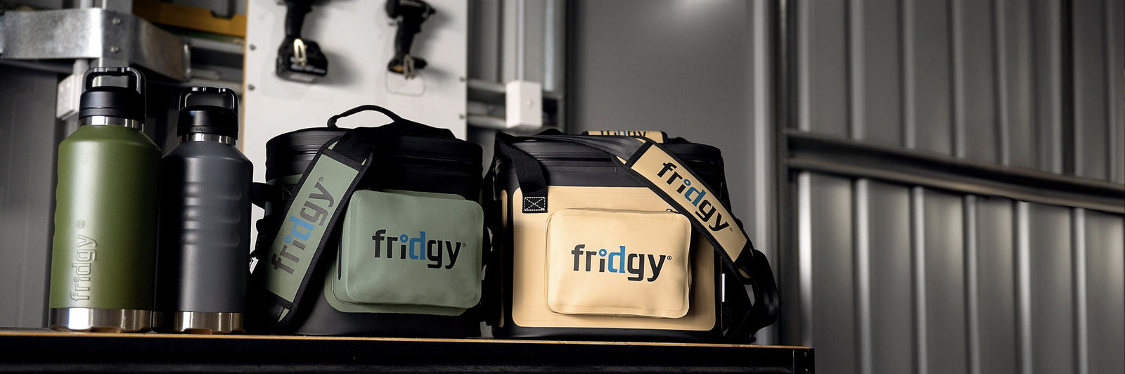 Fridgy 1.9L All-Dayer Bottles next to CribMate and CribMate+ Soft Coolers – Double-wall vacuum insulated stainless steel water bottles alongside durable, insulated soft coolers designed to keep food and drinks fresh for long workdays.