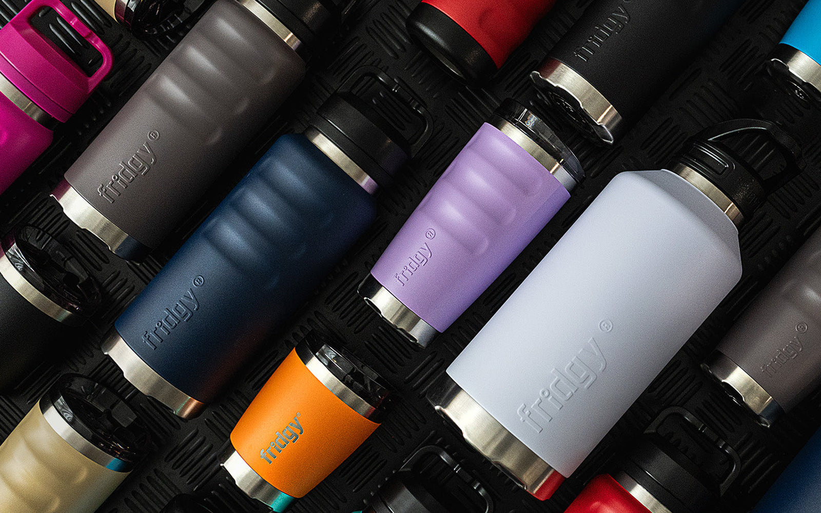 Full Fridgy Grip Range lineup in various colours, all products laying down – Triple-wall insulated stainless steel water bottles, tumblers, and can coolers designed for all-day hydration.