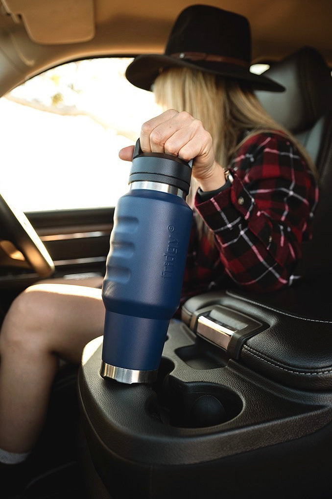 Fridgy Cruise Range Bottle being slid into a car cup holder – Double-wall vacuum insulated stainless steel drink bottle designed for travel-friendly hydration on the go.