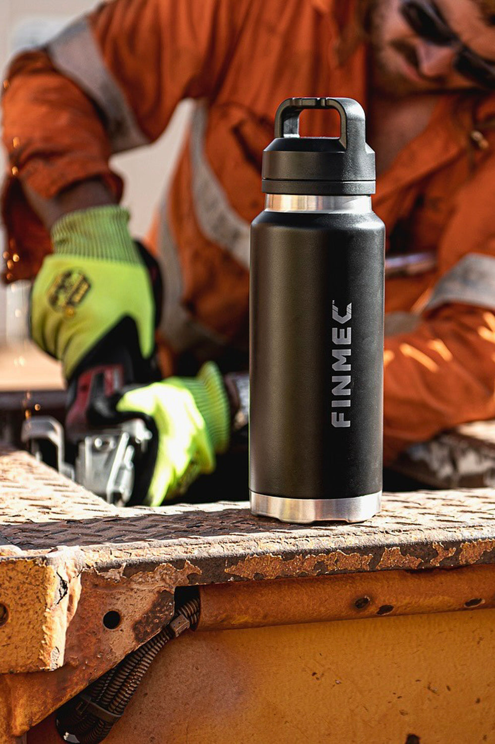 Person hard at work using a custom engraved Fridgy 1080ml Grip Range Bottle – Double-wall vacuum insulated stainless steel water bottle designed for durability and all-day hydration.