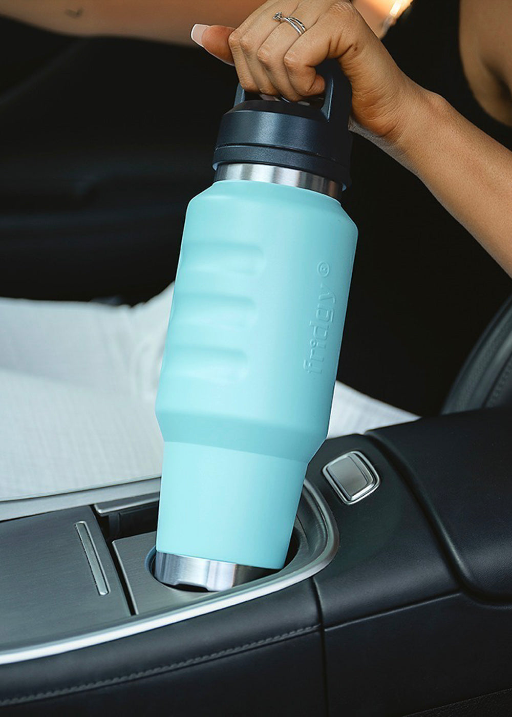 Fridgy 1L Cruise Range Bottle in Navy being taken out of a car cup holder – Triple-wall insulated stainless steel drink bottle designed for travel-friendly hydration.