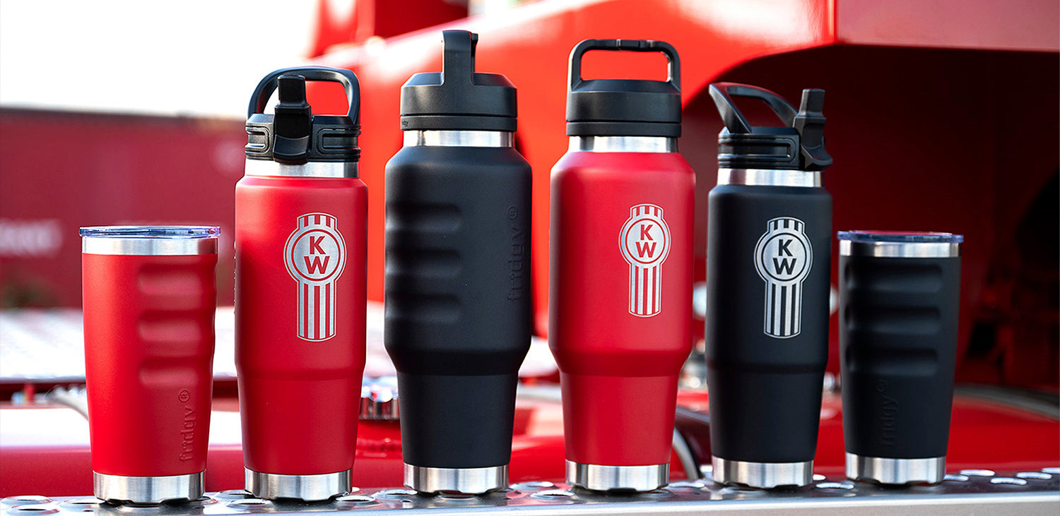 Fridgy 600ml Tumblers, 750ml Cruise Range Bottles, and 1L Cruise Range Bottles in Rebel Red and Dark Hour Black sitting on the step of a semi-trailer truck – Triple-wall insulated stainless steel drinkware built for durability and all-day hydration.